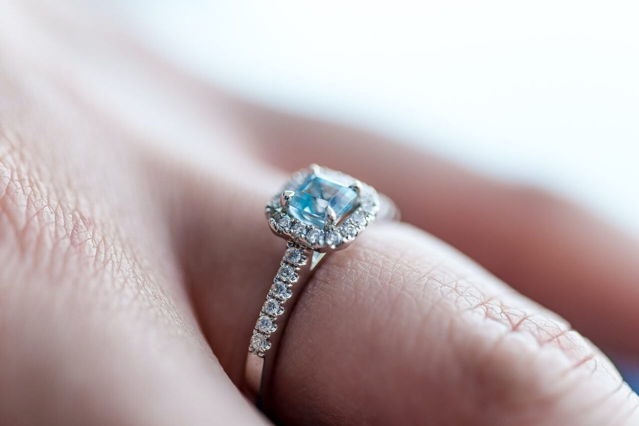 Prsten na ruci sa akvamarinom i dijamantima.